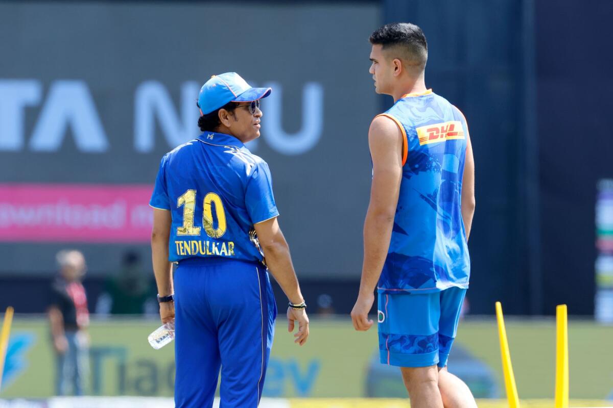 Arjun  Tendulkar speaks with Sachin Tendulkar before the start of the match against Kolkata Knight Riders. — IPL