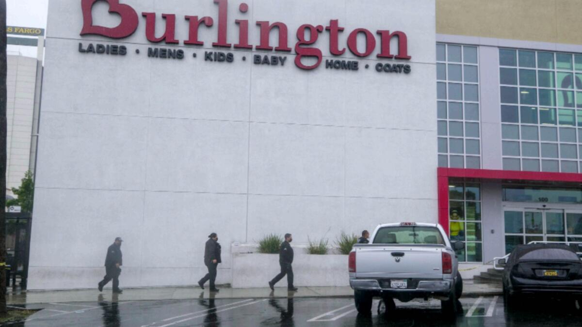 Police officers arrive the scene where two people were struck by gunfire in a shooting at the Burlington Coat Factory store in North Hollywood. — AP