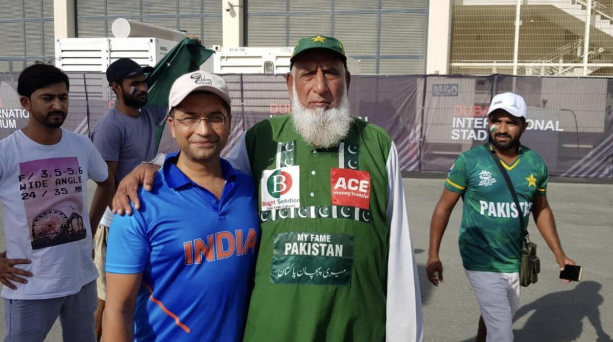 Famous Pakistan cricket fan Abdul Jalil (right) with an Indian fan before the start of the India-Pakistan Asia Cup match in Dubai last year. — Photo by Rituraj Borkakoty