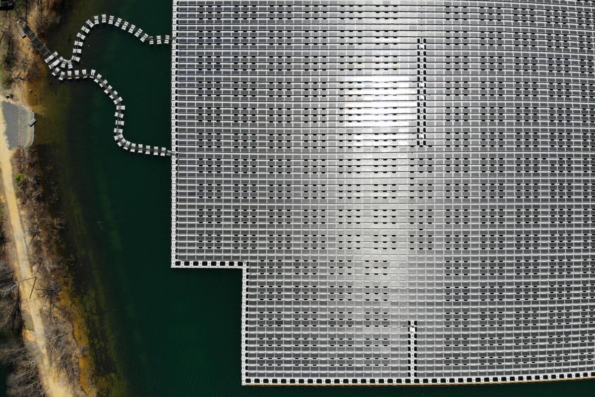 An array of solar panels float on top of a water storage pond in Sayreville, New Jersey on April 10, 2023. — AP