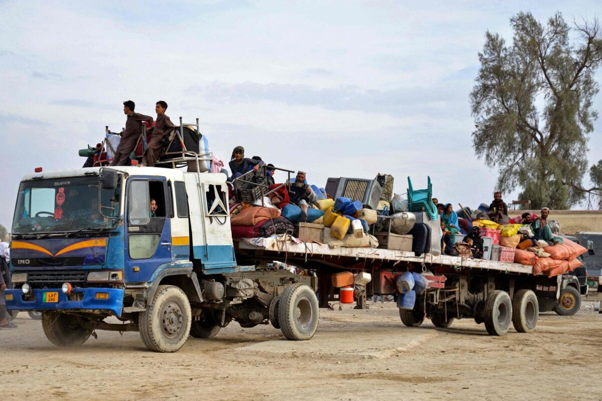 Afghan refugees with their belongings arrive on a truck from Pakistan, at a registration centre near the Afghanistan-Pakistan border in the Spin Boldak district of Kandahar province on November 6, 2023. — AFP