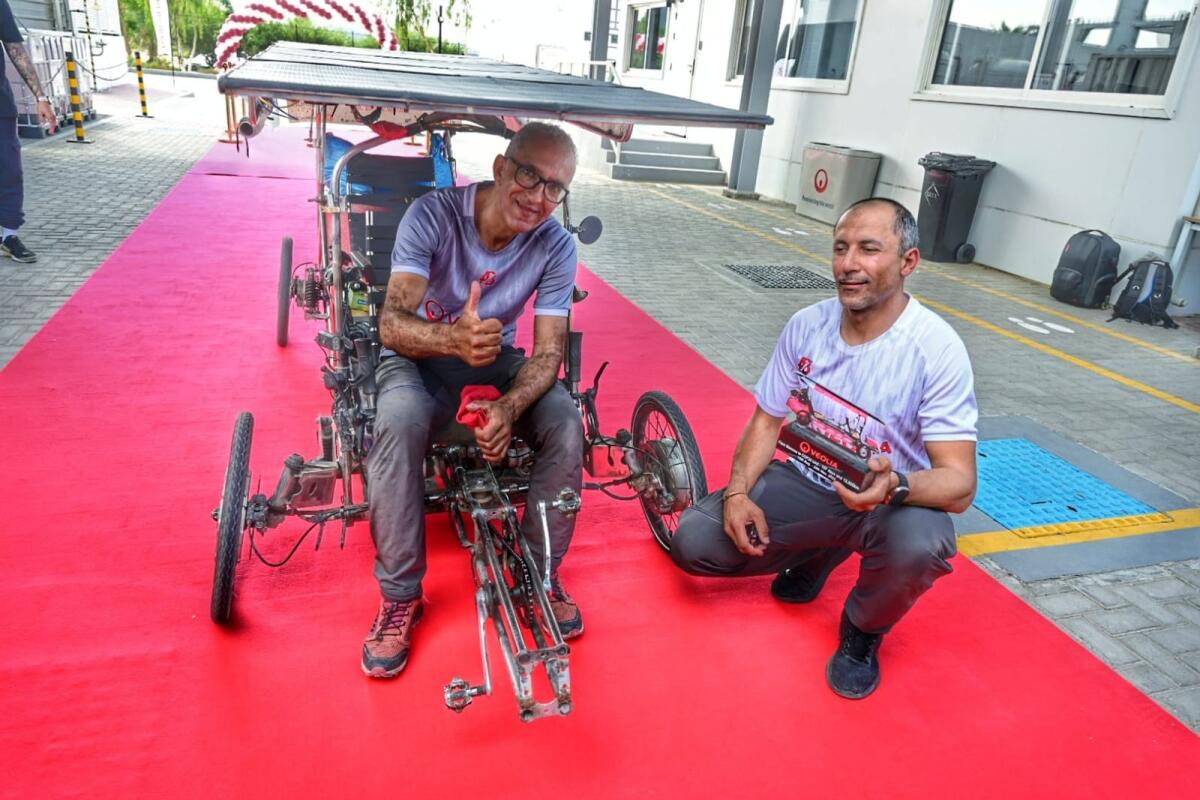 Yousef El Haouass and Salim Rhandi with their bycylcle. Photos: Shihab