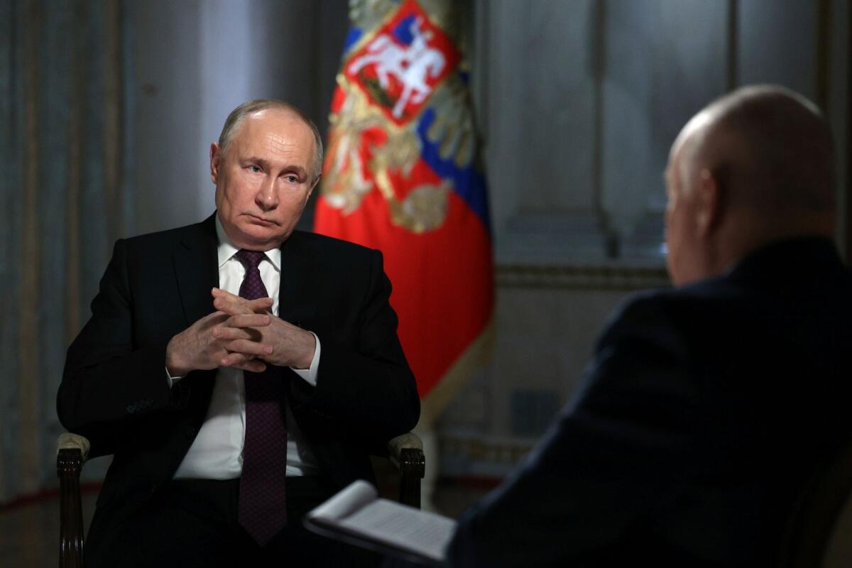 Russian President Vladimir Putin is interviewed by Rossiya Segodnya International Media Group Director General Dmitry Kiselev, back to a camera, in Moscow on Tuesday. — AP