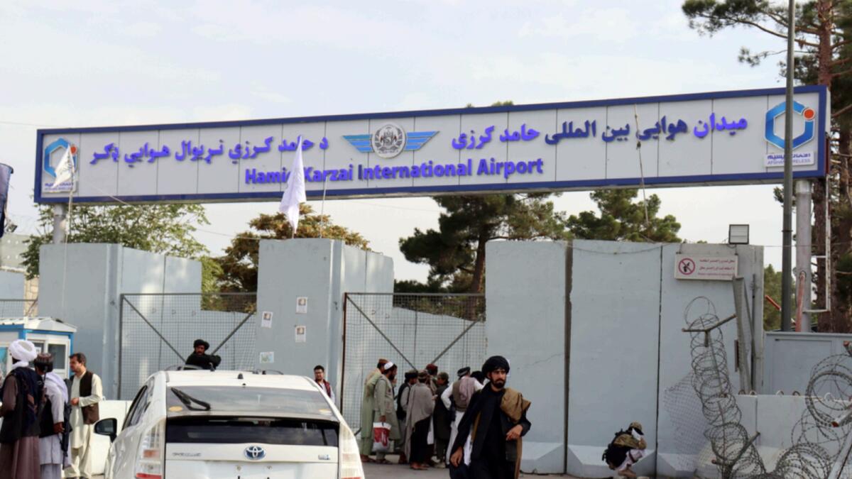 Taliban fighters stand guard in front of the Hamid Karzai International Airport after the US withdrawal in August. — AP file