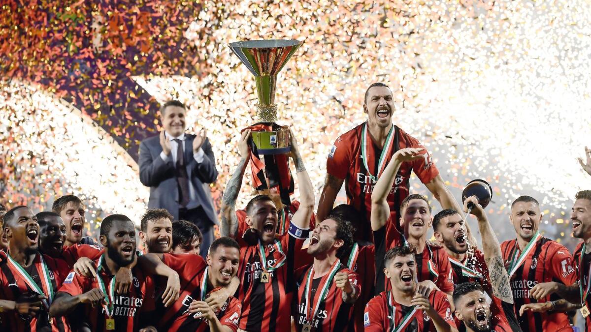 AC Milan celebrate with the Serie A trophy — AFP