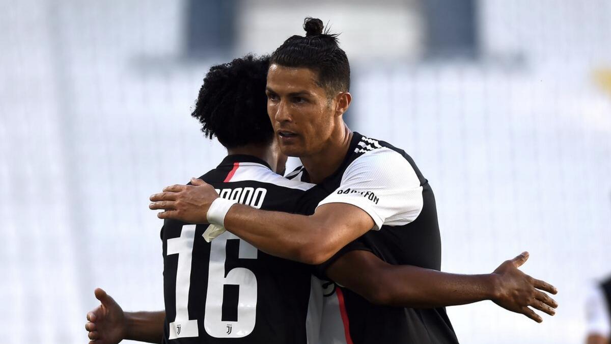 Juventus' Juan Cuadrado celebrates scoring their second goal with Cristiano Ronaldo (right). - Reuters