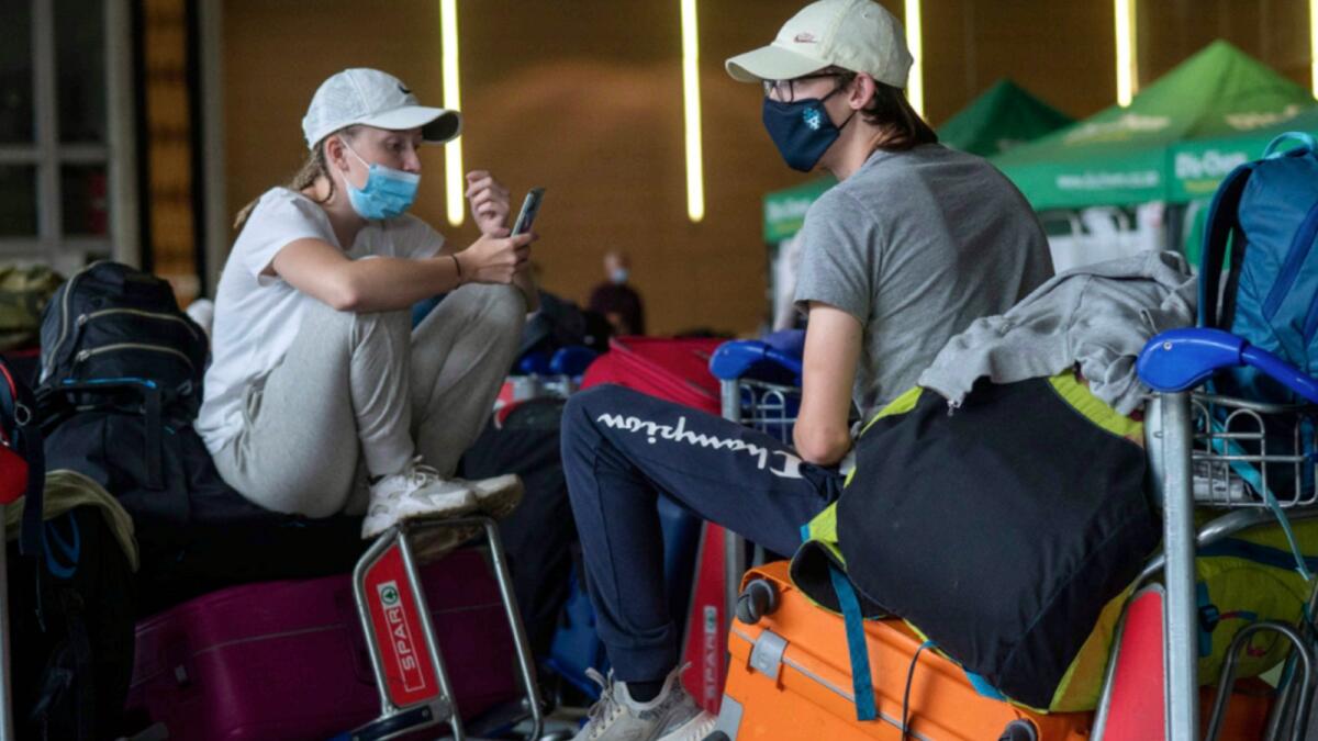 Students from Norway who were on a field trip to South Africa wait to be tested for Covid-19 before boarding a flight to Amsterdam at Johannesburg's OR Tambo's airport. — AP