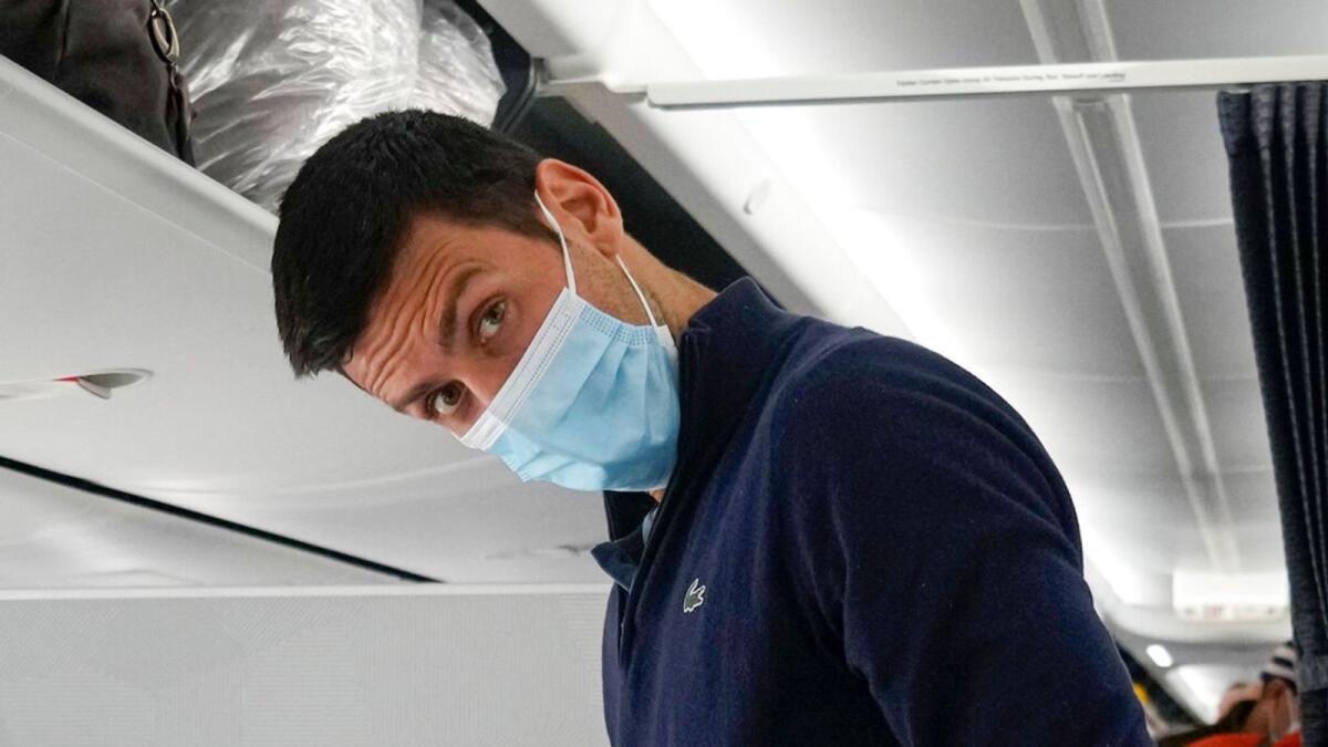 Djokovic prepares to take his seat on a plane to Belgrade, in Dubai on Monday.