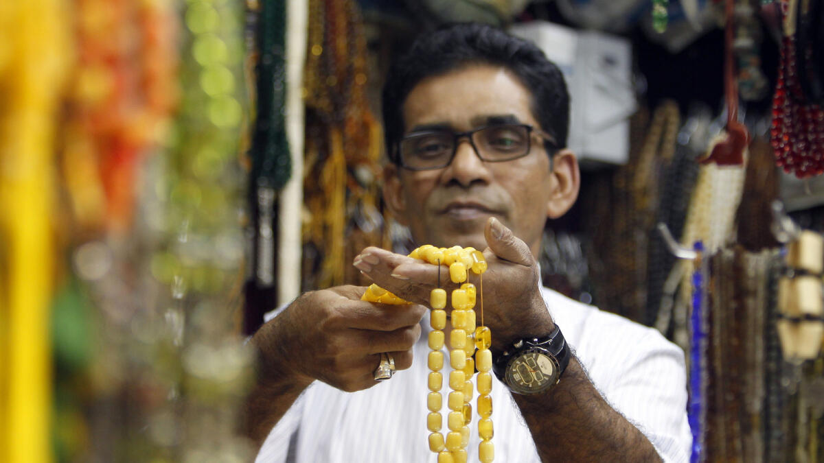 A BEAUTIFUL PRAYER ... Bangladeshi Tuhid ul Anwar holds a unique Misbaha — or the Tasbih — of natural stones at his shop.