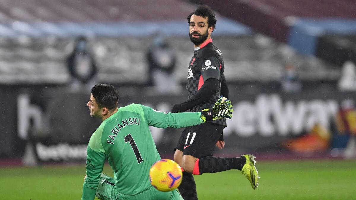 Liverpool's Mohamed Salah shoots past West Ham United's goalkeeper Lukasz Fabianski to score a goal. — AFP