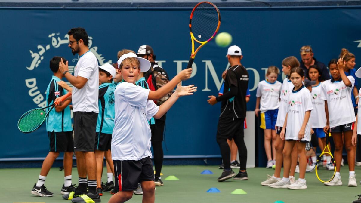 A young boy plays a return at the JP Morgan Kids’ Day. — dubai duty free tennis