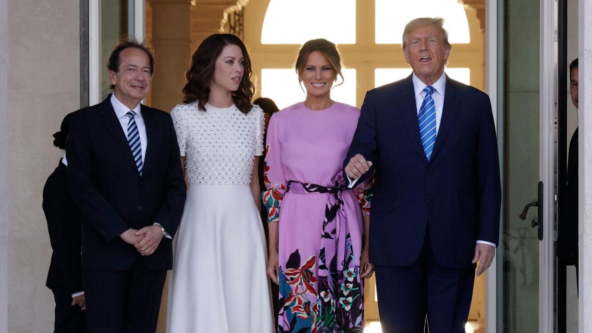 Republican presidential candidate and former US President Donald Trump (R) and former first lady Melania Trump (2nd-R) arrive at the home of John (L) and Jenny Paulson (2nd-L) on Saturday in Palm Beach, Florida. — AFP