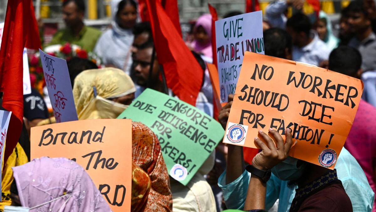 Victims of the Rana Plaza garments factory tragedy take part in a protest on its 10th anniversary at the site where the building once stood in Savar on the outskirts of Dhaka on Monday. — AFP