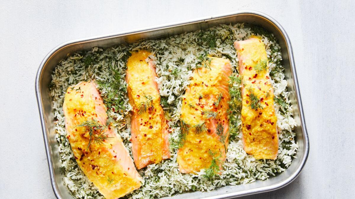 Baked salmon and dill rice. A large handful of emerald-green dill makes this dish from Naz Deravian as pretty as it is fragrant.  Food styled by Rebecca Jurkevich. (Linda Xiao/The New York Times)