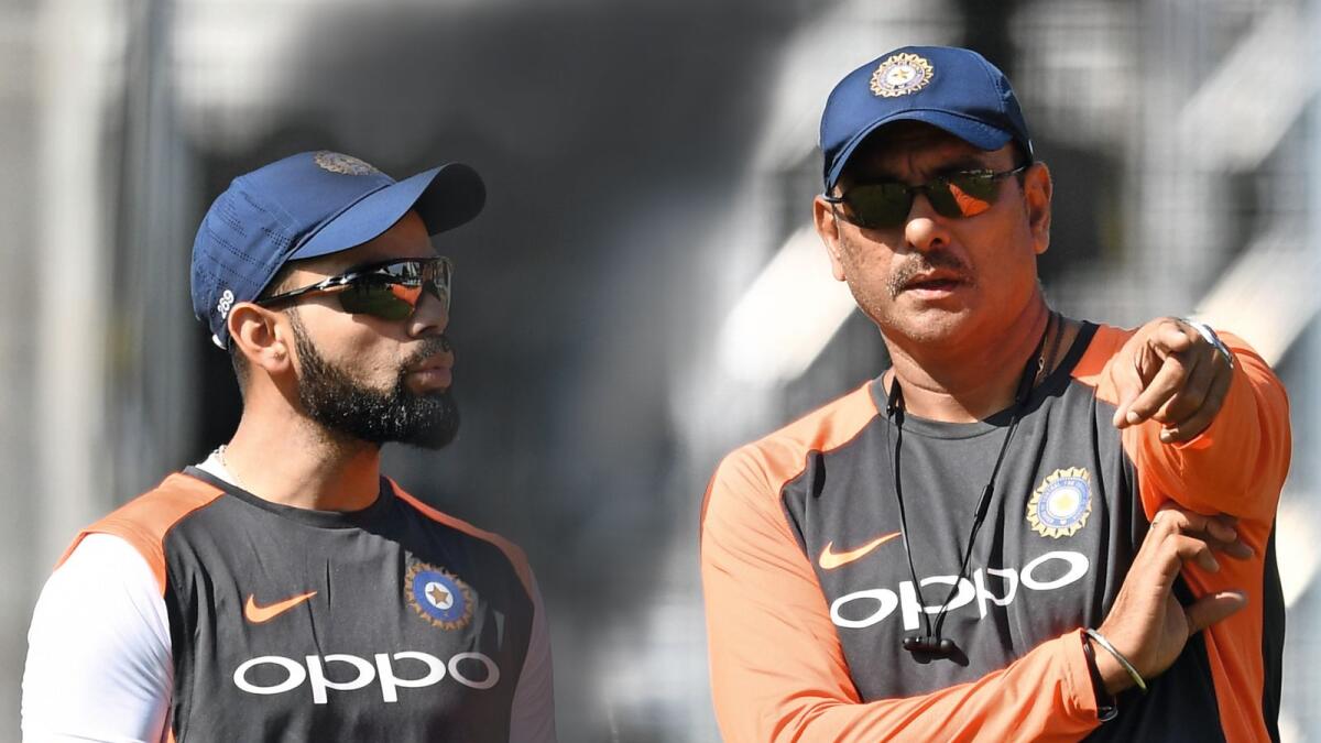 Outgoing coach Ravi Shastri (right) struck a good rapport with Virat Kohli. — AFP