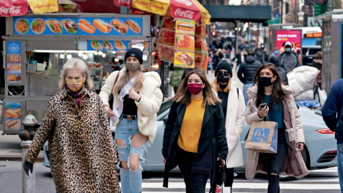 Women carry shopping bags in New York. — AP