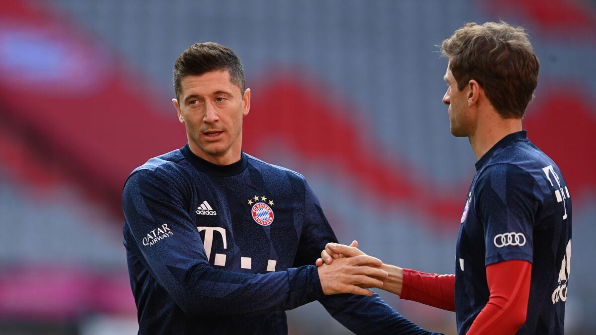 Bayern Munich's Robert Lewandowski and Thomas Muller during the warm up before the Bundesliga match Borussia Moenchengladbach. — Reuters