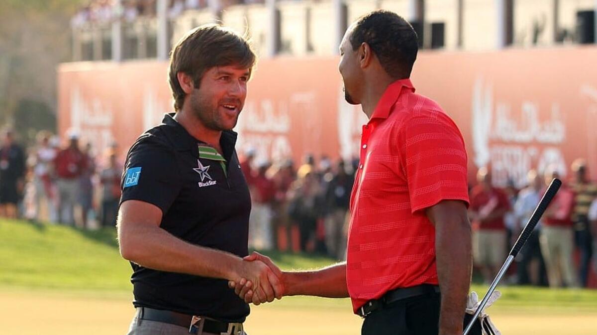Robert Rock shakes hands with Tiger Woods. . - Supplied photo
