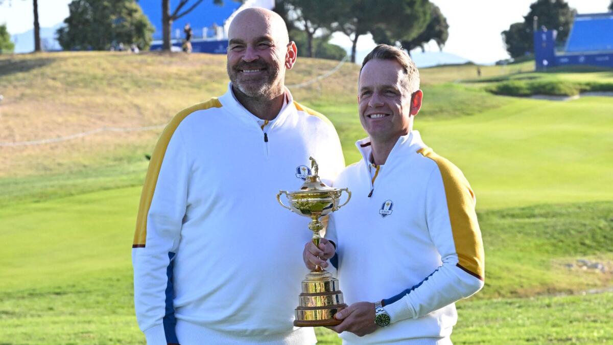 Europe's Danish vice-captain Thomas Bjorn (L) English captain, Luke Donald (R) pose with the trophy during the European team official team portraits ahead of the 44th Ryder Cup in Rome on September 26, 2023.  - AFP File