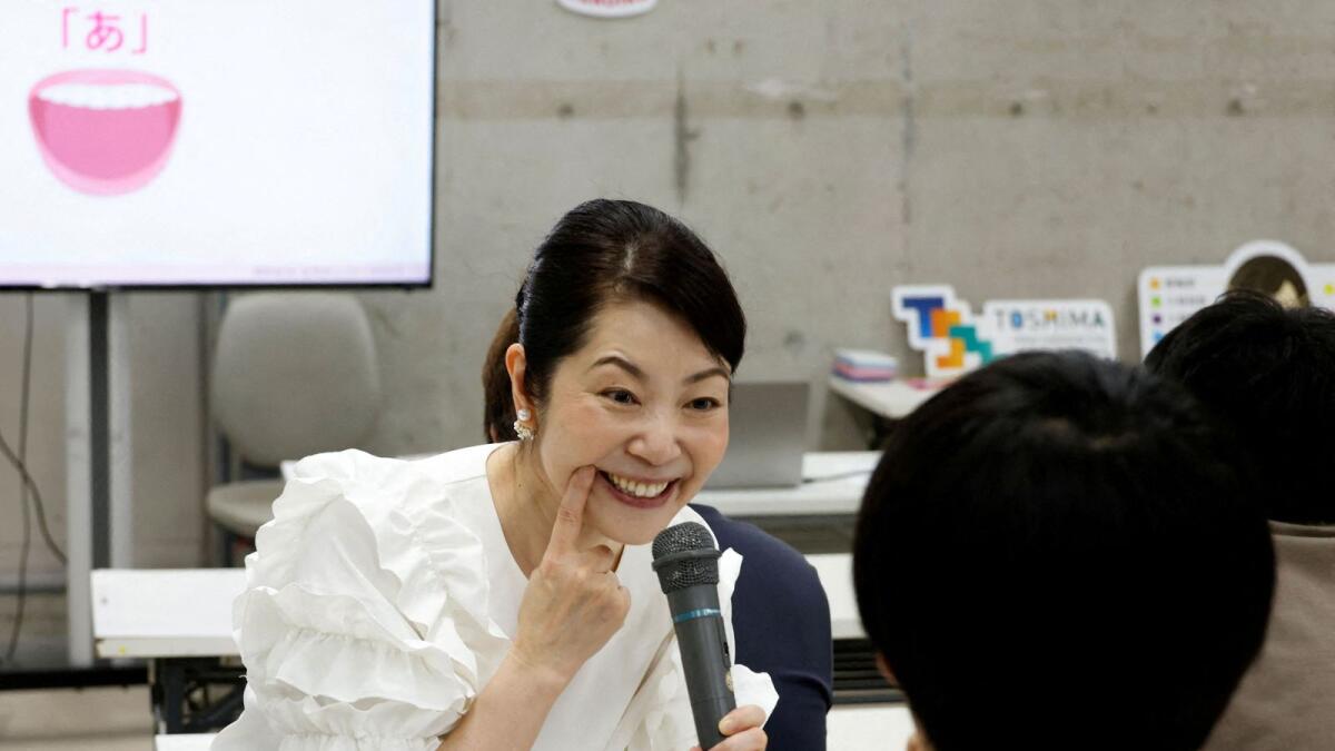 Smile coach Keiko Kawano teaches students at a smile training course at Sokei Art School in Tokyo, Japan, May 30, 2023. -- Reuters