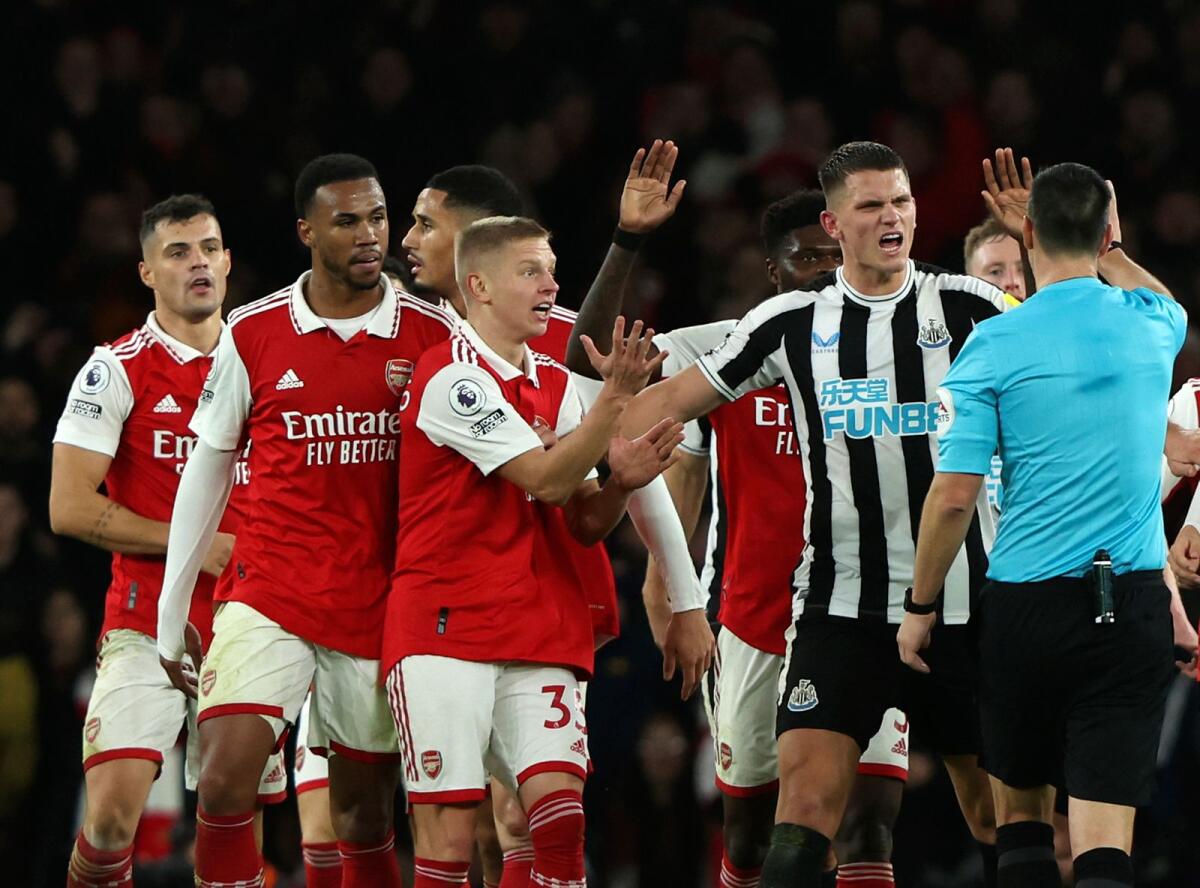 Referee Andy Madley controls the players after a foul in the Premier League match between Arsenal and Newcastle United. — AP