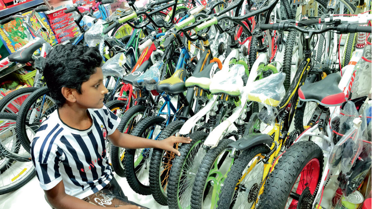 Which one is most colourful? A boy checks out some cycles. Photo by Shihab/Khaleej Times