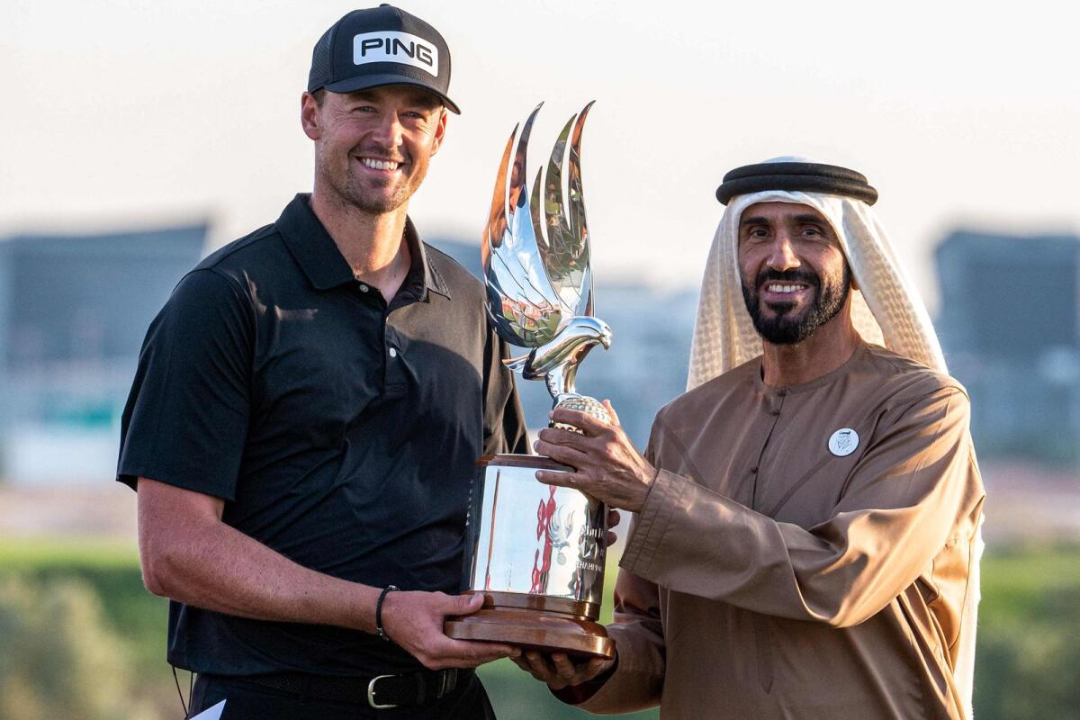 Sheikh Nahyan bin Zayed Al Nahyan (right), Chairman of Abu Dhabi Sports Council, presents the trophy to Victor Perez of France after he won the Abu Dhabi HSBC Championship. — AFP