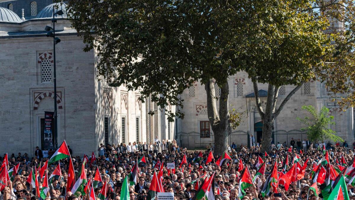 Protestors shout slogans and wave flags during a demonstration to show solidarity with the Palestinian people, after Friday prayers in Istanbul. — AFP