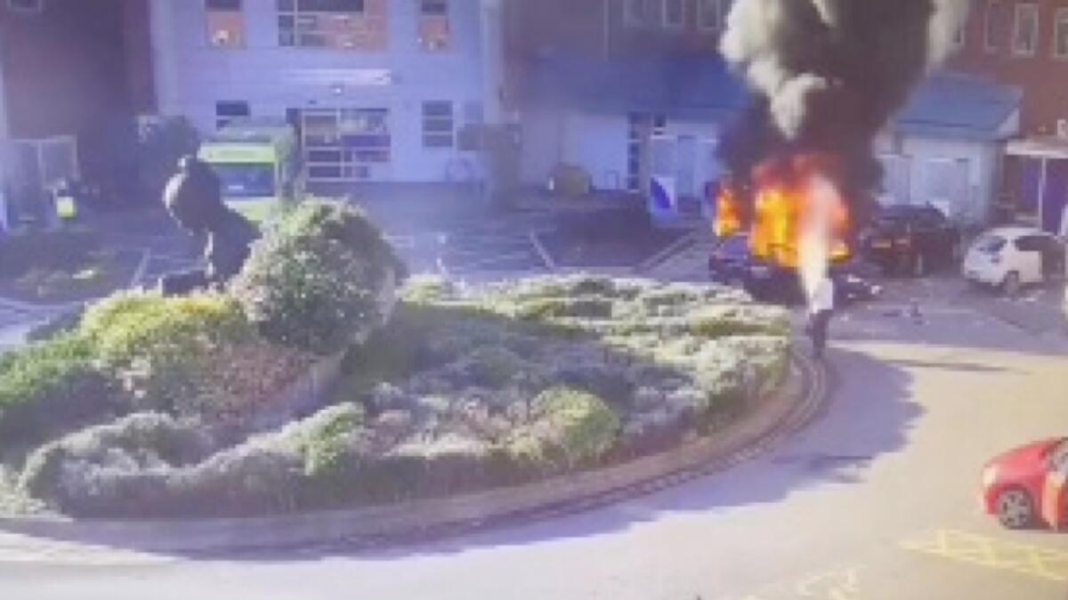 A surveillance camera footage shows a man extinguishing a burning taxi following an explosion outside Liverpool Women's hospital in Britain. –Reuters