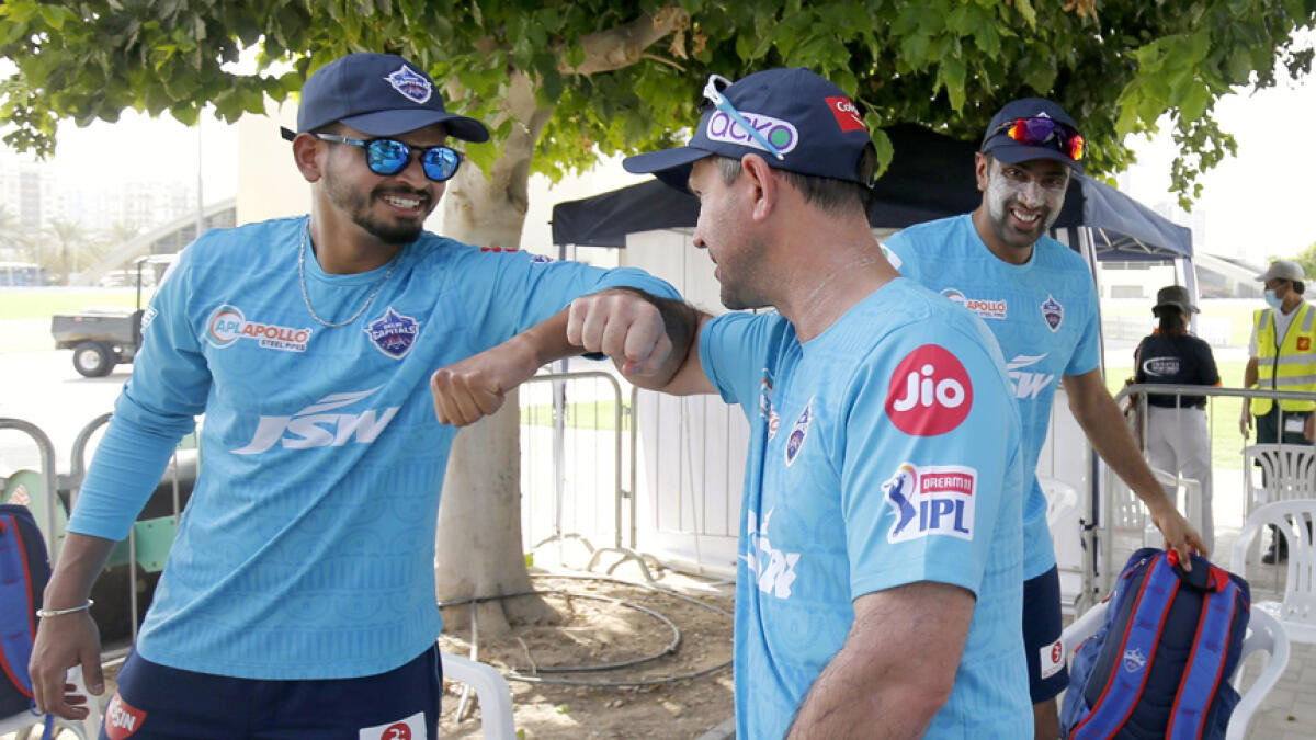 Ravichandran Ashwin (right) watches as Delhi Capitals' captain Shreyas Iyer (left) and coach Ricky Ponting share a light moment during their practice session. - Delhi Capitals Twitter