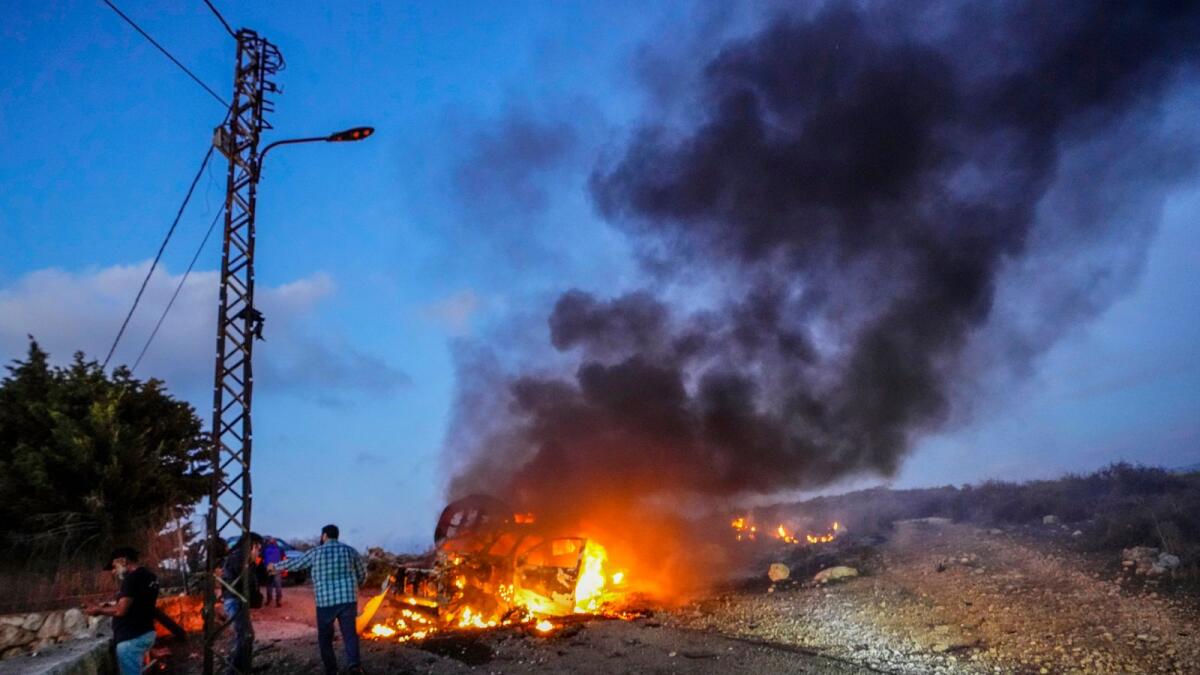 Qatar's Al-Jazeera TV car burns after it was hit by Israeli shelling in the Alma Al Shaab in South Lebanon on October 13, 2023. — AP