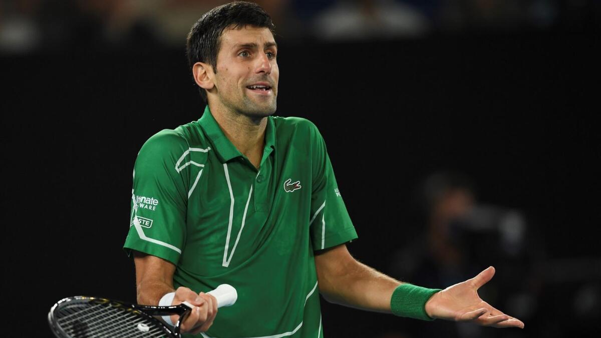 (FILES) This file photo taken on February 2, 2020 shows Serbia's Novak Djokovic reacting after a point against Austria's Dominic Thiem during their men's singles final match on day fourteen of the Australian Open tennis tournament in Melbourne. - Photo: AFP