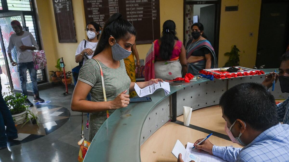 People register for a dose of the Covishield vaccine at a vaccination centre in New Delhi. Photo: AFP