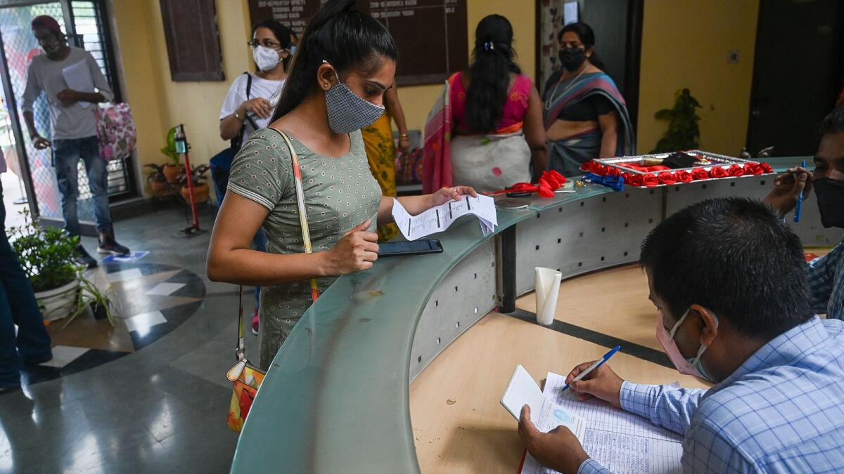People register for a dose of the Covishield vaccine at a vaccination centre in New Delhi. Photo: AFP