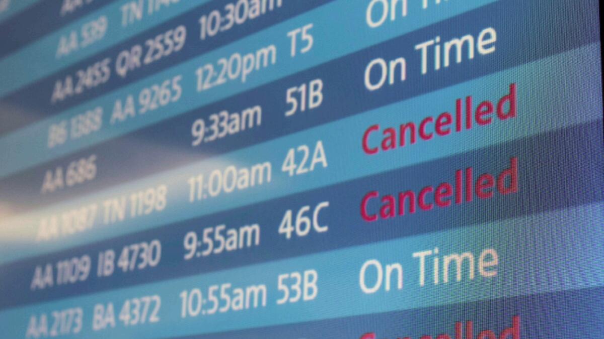 A screen showing cancelled flights is seen at Los Angeles International Airport. — Reuters