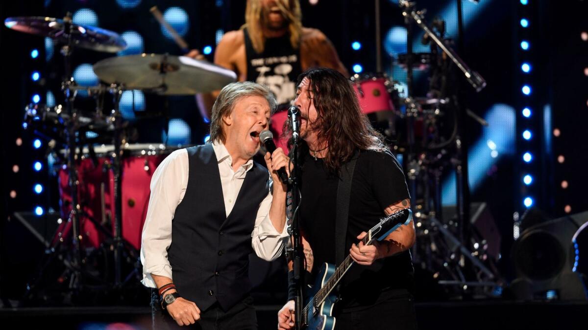 Sir Paul McCartney performs the Beatles song 'Get Back' with the Foo Fighters after they were inducted into the Rock and Roll Hall of Fame in Cleveland, Ohio, U.S. October 31, 2021. (REUTERS)
