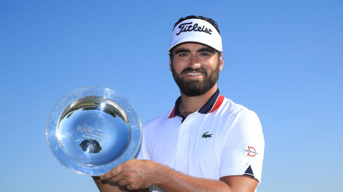 Antoine Rozner of France with the trophy after winning the Golf in Dubai Championship in Dubai on Saturday. — Getty Images