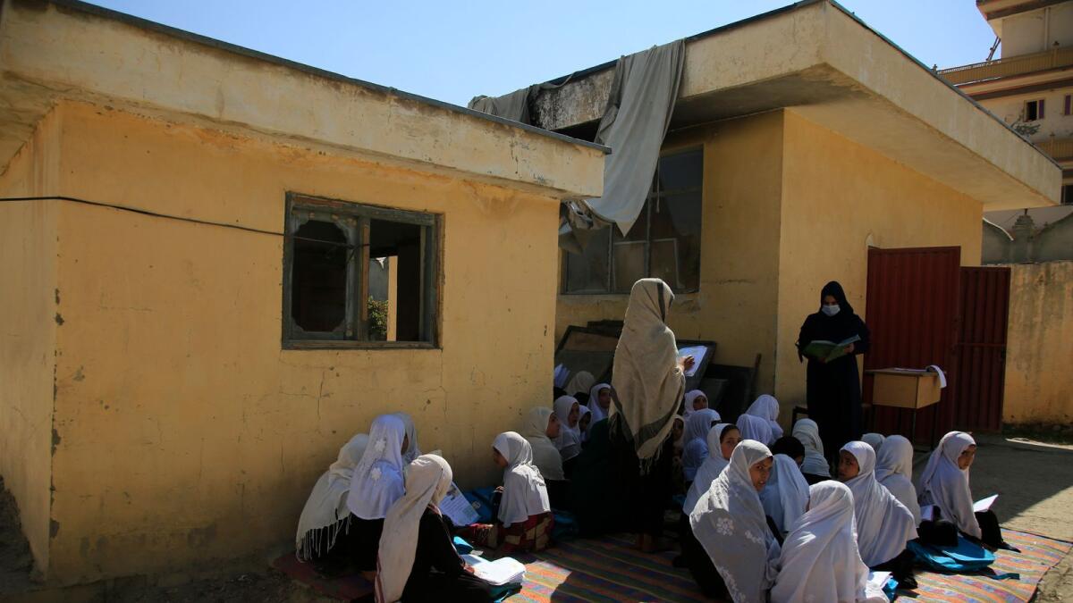 Afghan students attend an open air class at a primary school in Kabul.