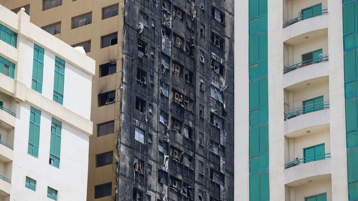 Hundreds of Sharjah tenants watched from the streets as firefighters battled a huge blaze that gutted their 48-storey building on Tuesday night.