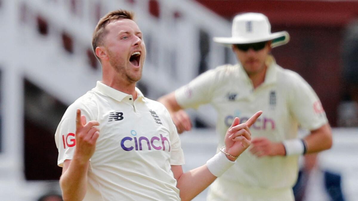 England's Ollie Robinson celebrates taking the wicket of New Zealand's Ross Taylor on the first day of the first Test against New Zealand at Lord's. (AFP)