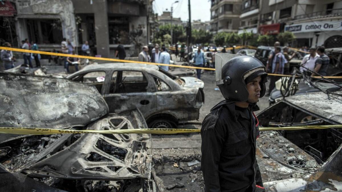 An Egyptian policeman stands guard at the site of a bombing.