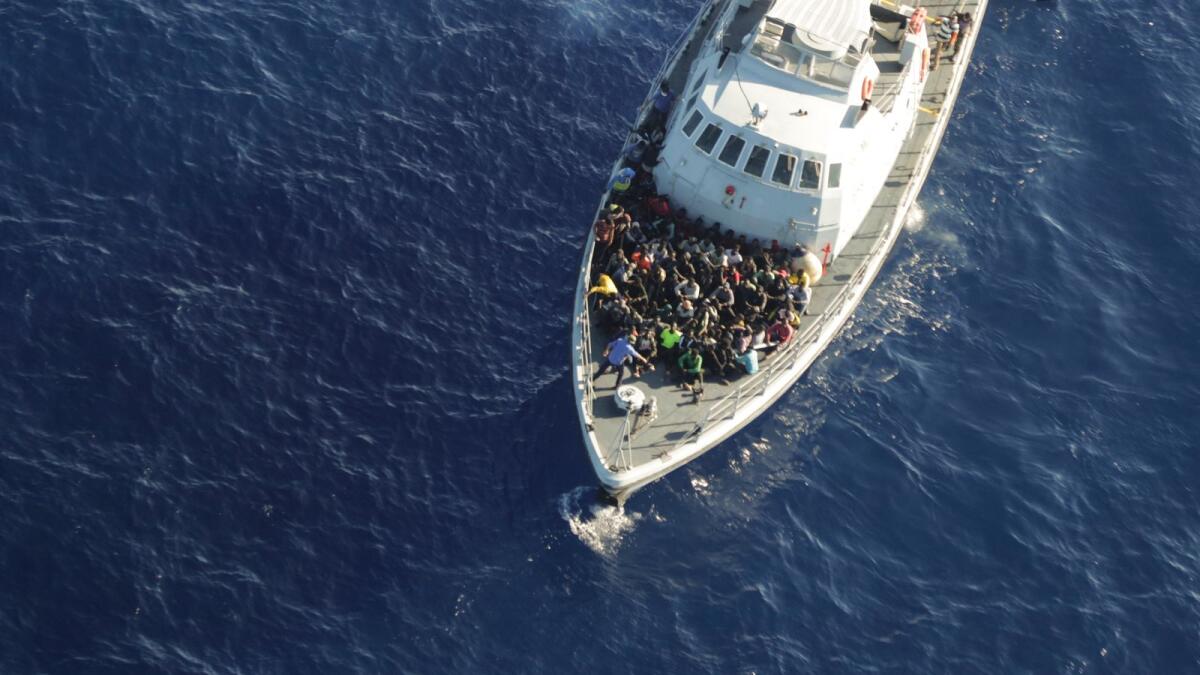 In this handout photo released by German non-governmental organization Sea-Watch on Tuesday, Oct. 25, 2022, migrants sit on the deck of a Libyan coast guard ship after being intercepted while trying to cross the Mediterranean Sea on a rubber boat to Europe. — AP file used for illustrative purpose only