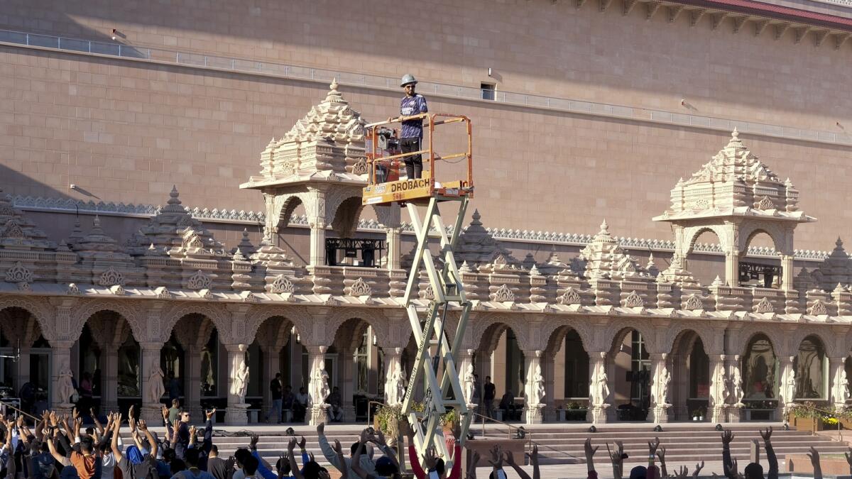 Worshippers practice a routine for the grand dedication ceremony of the BAPS Swaminarayan Akshardham. — AP