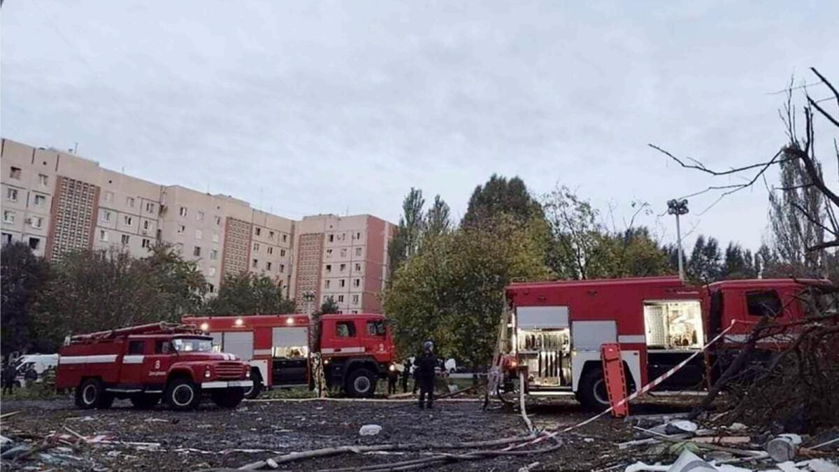 Rescuers work at the scene of damages after shelling in Zaporizhzhia. — AP