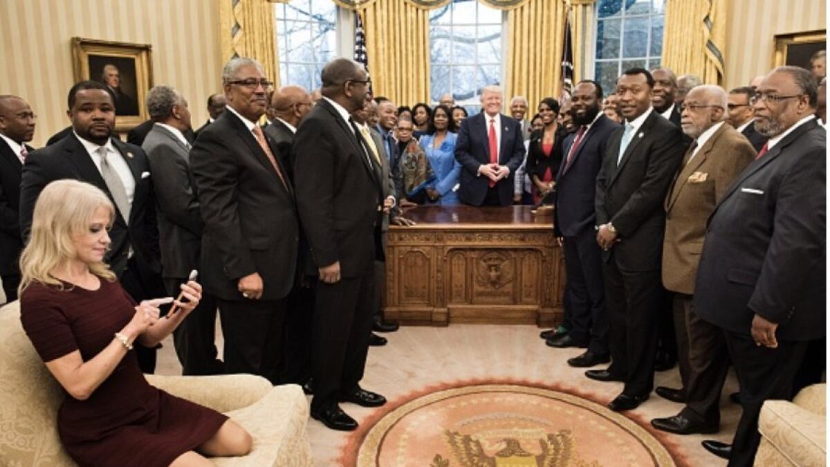 Trump aide kneels on White House sofa with shoes on 