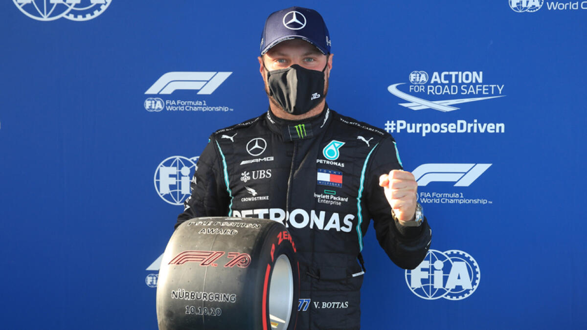 Mercedes' Valtteri Bottas poses as he celebrates after qualifying in pole position. - Reuters