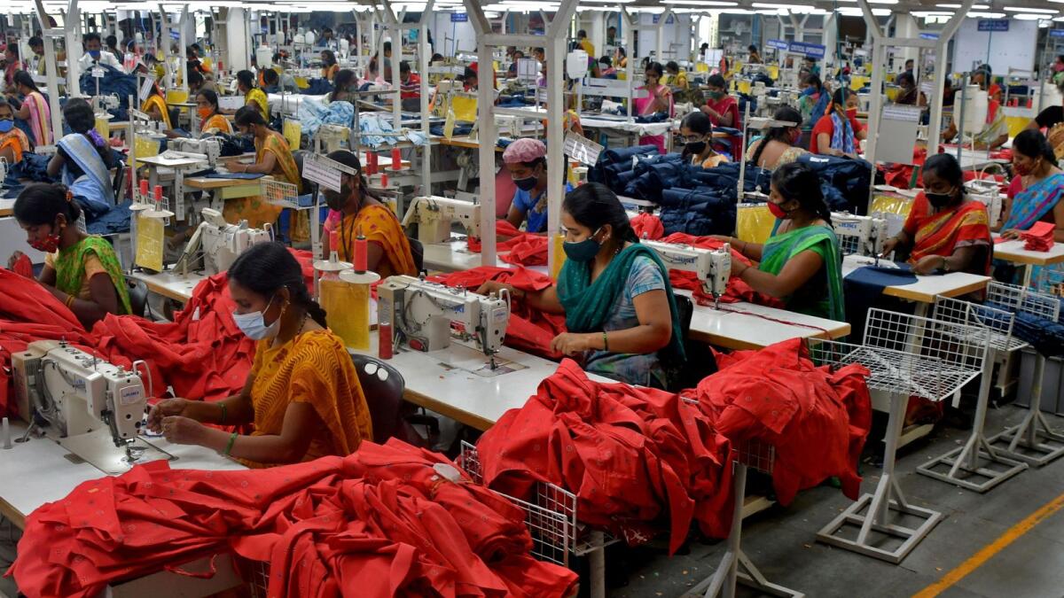 Garment workers stitch shirts at a textile factory in Andhra Pradesh. India is the only economy that looks promising amid the gloomy global picture. — Reuters file photo