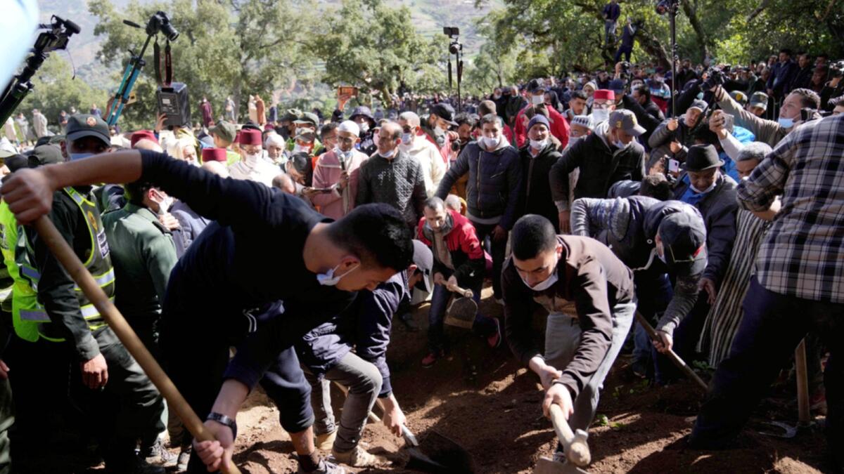 Workers cover the grave dug for 5-year-old Rayan during his funeral after his body was retrieved from a deep well, in the village of Ighran in Morocco's Chefchaouen province. — AP