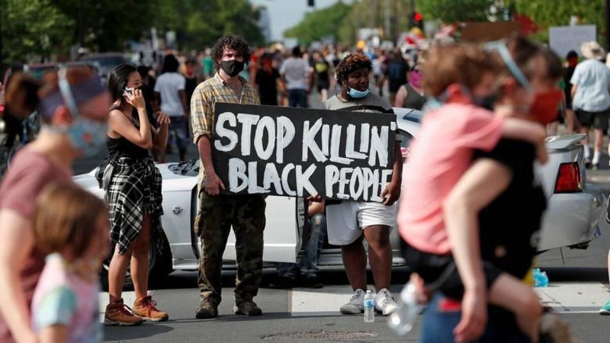Protesters gather at the scene where George Floyd, an unarmed black man, was pinned down by a police officer kneeling on his neck before later dying in hospital in Minneapolis, Minnesota, U.S. May 26, 2020.