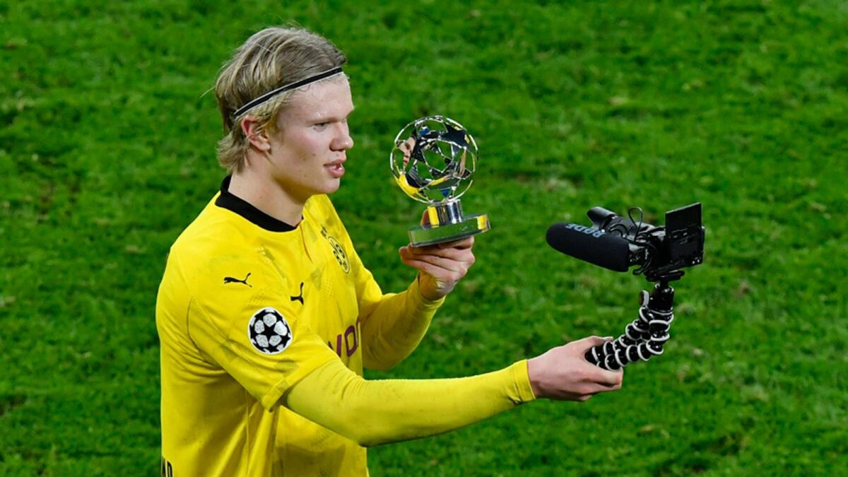 Dortmund's Erling Haaland films himself with a trophy for a man of the match after the Champions League, round of 16, second leg match against Sevilla FC in Dortmund, Germany. — AP